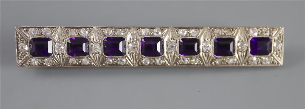 An early to mid 20th century 18ct white gold, amethyst and diamond cluster set bar brooch,